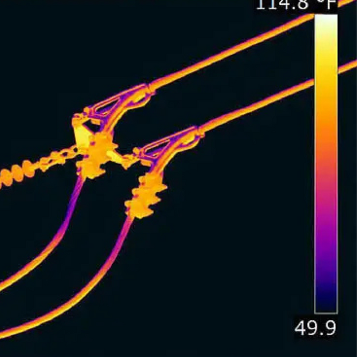 Teledyne Flir T1020 Kit 12 45 closeup thermal view of overhead power lines and insulators highlighted with heat signature.