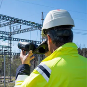 Teledyne Flir T530 Dfov 14 24 technician using camera to scan substation from behind.