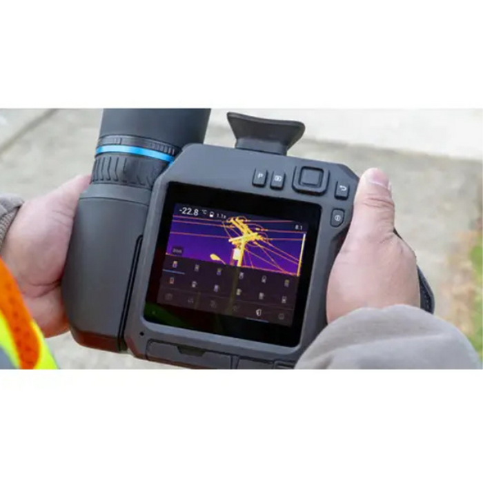 Teledyne Flir T840 24 6 hands holding camera thermal display of power lines.