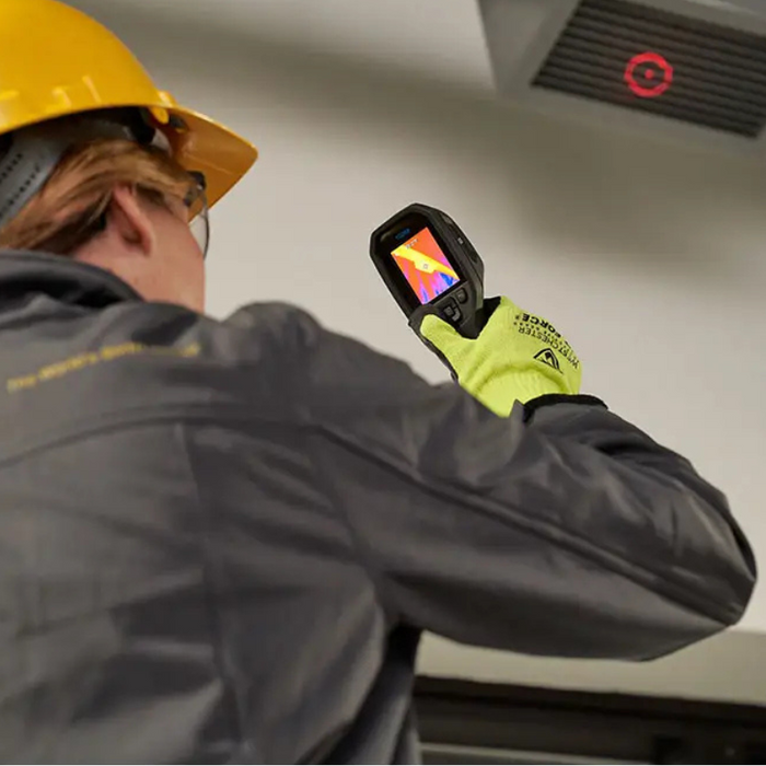 Teledyne Flir Tg268 inspection upward view technician using camera on ceiling vent.