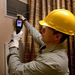 Teledyne Flir Tg268 technician using camera on air vent with hardhat and gloves.