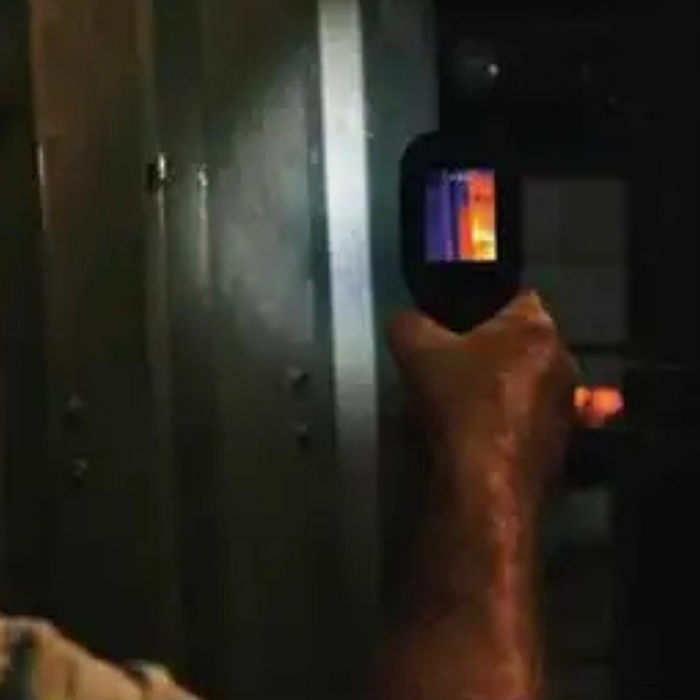 Teledyne Flir Tg297 in use view aimed at metal panel in dark setting.