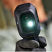 Teledyne Flir Tg298 front view flash on gloved hand holding camera.