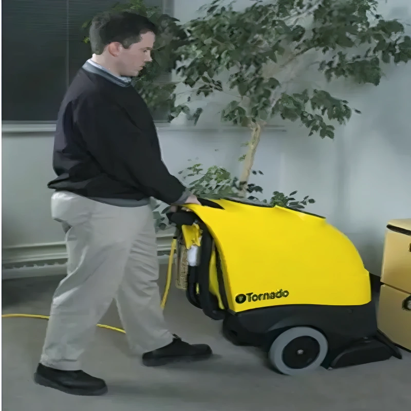 Tornado 20 Marathon 1200 Self Contained 12 Gallon Carpet Extractor in use man operating yellow body black base.