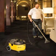 Tornado Marathon 350 Carpet Spotter Extractor person using hotel carpet cleaning yellow body.