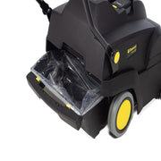 Tornado Tempest Wide Area Carpet Sweeper Vac dust bin open black body yellow wheels.