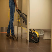 Tornado Vortex 13 multi surface auto scrubber cleaning under stall bathroom yellow black.