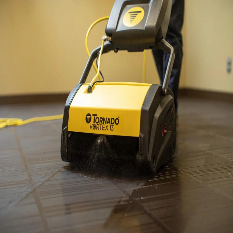Tornado Vortex 13 multi surface auto scrubber spraying water floor cleaning yellow black.