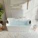 Modern white rectangular bathtub with water, black headrests, set in elegant marble-tiled bathroom with geometric floor pattern and houseplant.