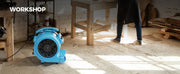 AlorAir GE2000T on a sawdust-covered workshop floor, with a Workshop label