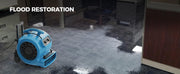 AlorAir GE3000HTC drying a flooded office carpet, with a Flood Restoration label