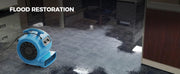 AlorAir GE3000T drying a flooded office carpet, with a Flood Restoration label