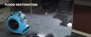 AlorAir GE4000T drying a flooded office carpet, with a Flood Restoration label
