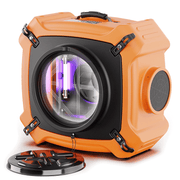 Orange AlorAir PureAiro HEPA Max 970 air scrubber, front three-quarter view with the UV-C lamp glowing inside the inlet
