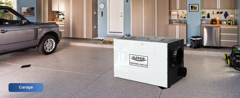 AlorAir Sentinel WHD150 on a garage floor beside a parked car, labeled Garage