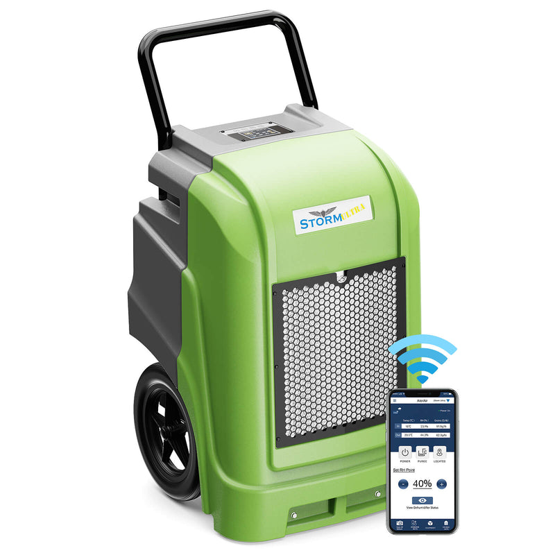 AlorAir Storm Ultra in green and gray, front three-quarter view with its handle, beside a phone showing the AlorAir app