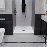 ANZZI SB-AZ102C Shower Base installed in a bathroom, front room view