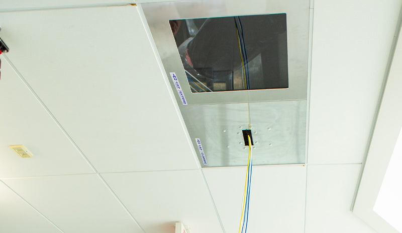 CAP Classic and CAP Extend installed in a ceiling grid with cable through the brush slot