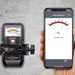 Tramex Flooring Installer Tech Kit - FTK A close-up image of the Tramex CME5 extension handle attached to an iPhone, designed for moisture measurement in flooring installations. The handle features a sturdy grip and connects seamlessly to the smartphone device.