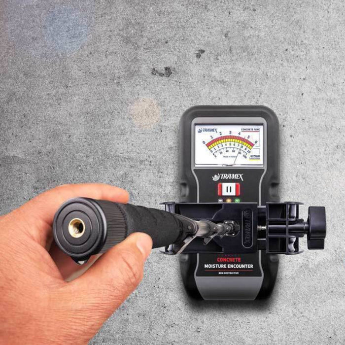 Tramex Flooring Inspector Kit - FIK A portable moisture meter with an extension handle, designed for inspecting flooring materials, featuring a digital display and a rugged design.