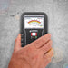Tramex CME5 - Concrete Moisture Encounter CME5; an image showing the Tramex CME5 moisture meter being held in a hand while resting on a concrete floor, illustrating its use in measuring moisture levels in concrete surfaces.