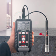 Tramex CMEX5 - Concrete Moisture Encounter CMEX5, an image depicting the CMEX5 moisture meter designed for measuring moisture levels in concrete. The device features a digital display, multiple buttons, and an attached probe, all set against a neutral background, showcasing its sleek design and functionality.