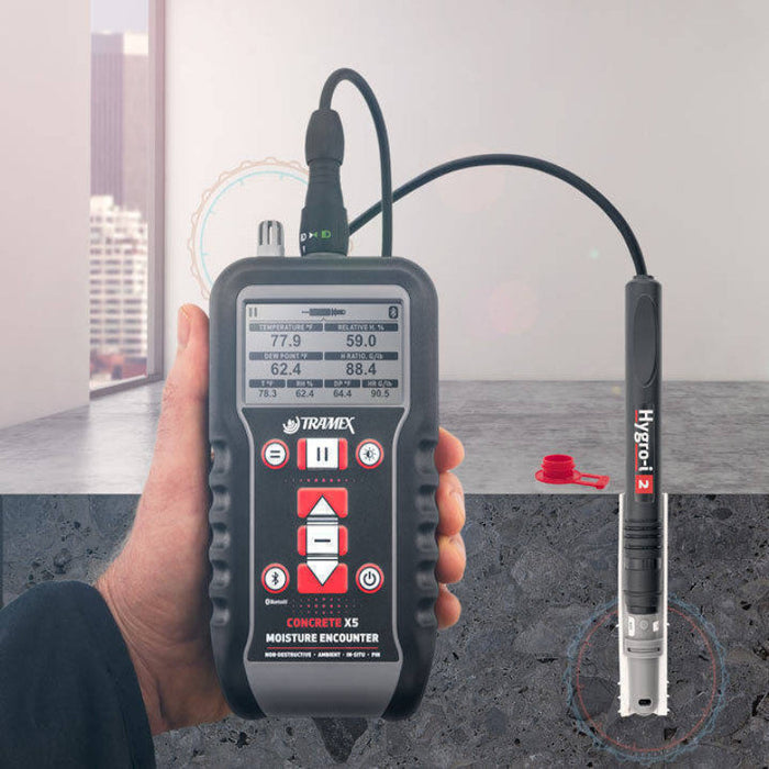 Tramex CMEX5 - Concrete Moisture Encounter CMEX5, an image depicting the CMEX5 moisture meter designed for measuring moisture levels in concrete. The device features a digital display, multiple buttons, and an attached probe, all set against a neutral background, showcasing its sleek design and functionality.