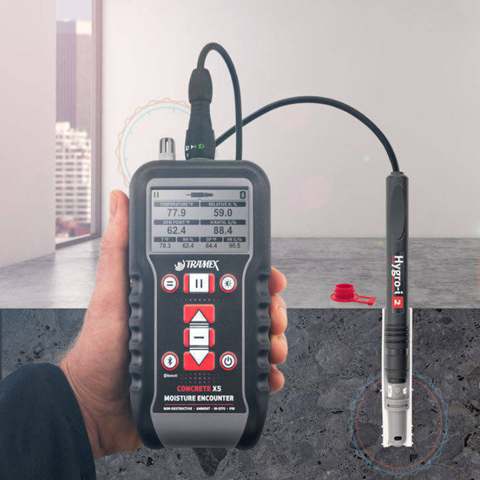 Tramex Flooring Master Kit - FMK Image showing the CMEX5 Hygro-i2 probe with application setup for measuring moisture in concrete and wood floors, featuring digital display and components utilized for psychrometric analysis.