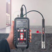 Tramex Flooring Inspector EZ Kit - FZK: A detailed image showing the Tramex CMEX5 Hygro-i2 Probe, used for in-situ testing of flooring materials. The probe features an ergonomic design, along with a digital display that indicates moisture levels and psychrometric measurements.