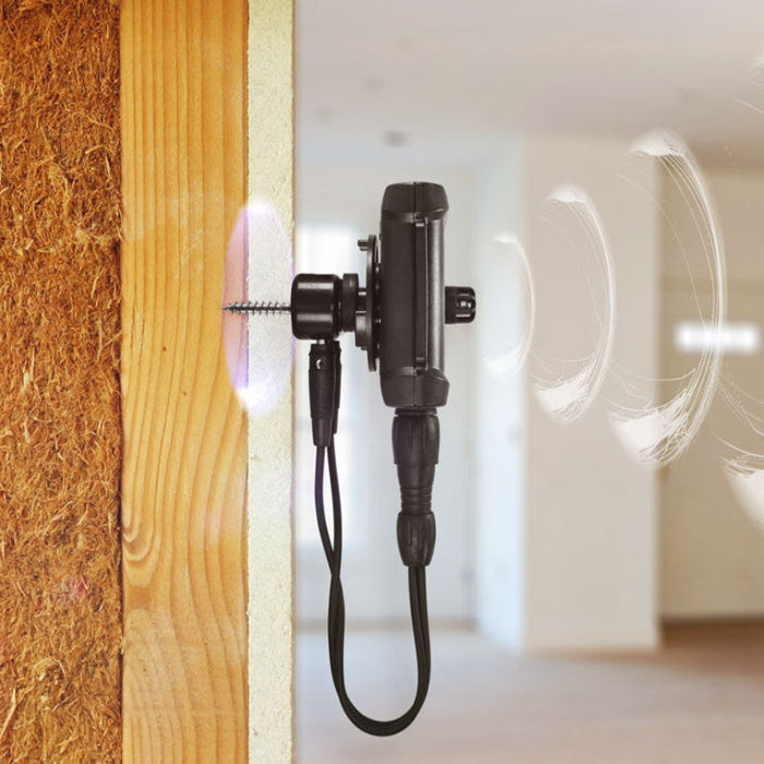 Tramex AP-TREMS-WME-MC - Remote Environmental Monitoring System WME/MC Accessory Pack. The image shows the Tramex Remote Environmental Monitoring System mounted on drywall in a residential hall, featuring a sleek design and a wireless contact sensor for humidity and temperature monitoring.