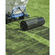 Dapper Supply 36-inch compost spreader towed behind a broadcast spreader on turf.