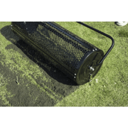 Dapper Supply 44-inch compost spreader laying down material on grass closeup.