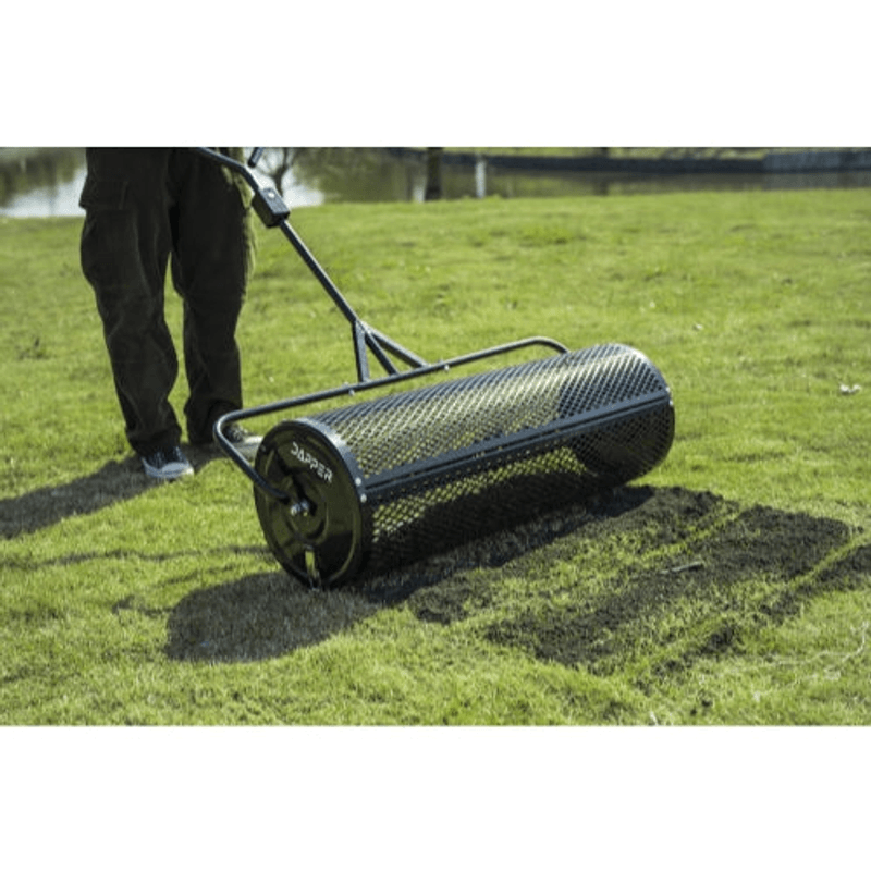 Dapper Supply 44-inch compost spreader used walk-behind on a lawn.