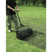 Dapper Supply compost spreader spreading material evenly across a backyard lawn.