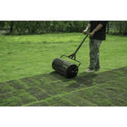 Dapper Supply compost spreader covering a wide lawn area during top-dressing.