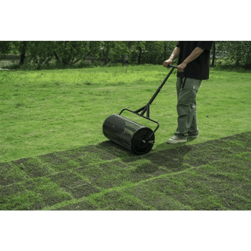 Dapper Supply compost spreader covering a wide lawn area during top-dressing.