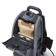 Dapper Supply cordless backpack vacuum with the dust bag compartment open.
