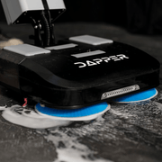 Dapper Supply 16-inch battery walk-behind floor scrubber cleaning a tile floor.