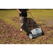 Dapper Supply lawn sweeper collecting fallen leaves while in use.