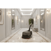 Dapper Supply mini automatic floor scrubber cleaning a marble hallway floor.