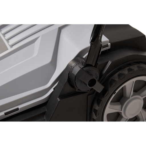 Dapper Supply push floor sweeper handle height adjustment knob and wheel close up.