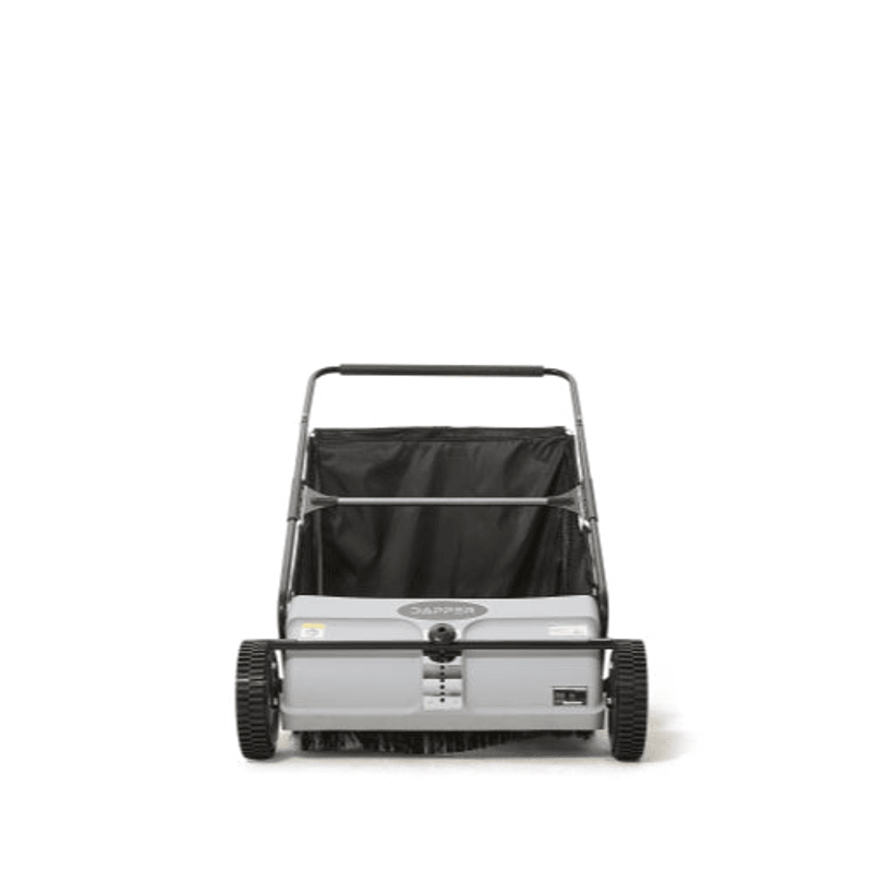Dapper Supply push lawn sweeper front view showing brush roller and wheels.