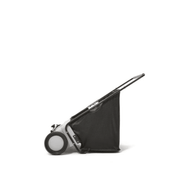 Dapper Supply push lawn sweeper side view with handle and hopper bag.