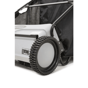 Dapper Supply push lawn sweeper closeup of a drive wheel and sweeping brush.