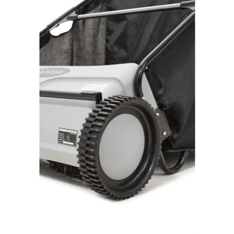 Dapper Supply push lawn sweeper closeup of a drive wheel and sweeping brush.