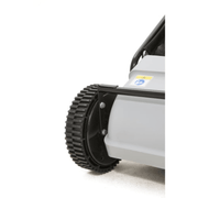 Dapper Supply push lawn sweeper closeup of the treaded wheel and brush housing.