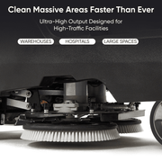 Dapper Supply ride-on floor scrubber underside showing the rotary scrub brushes.