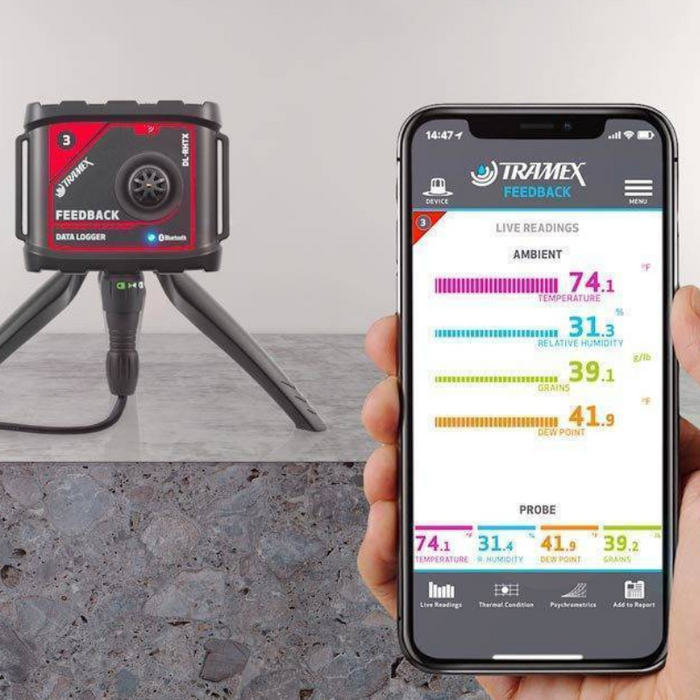 Tramex Water Damage Restoration Master Kit - WDMK Image showing the handheld device from the Tramex Water Damage Restoration Master Kit, designed for detecting moisture levels in various materials. The device features a digital display and is shown in a concrete environment, emphasizing its application for in-situ measurements.