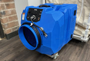 Blue negative air machine on the ECU4 Tow Cart beside a collapsed ECU4, the setup in kits with a machine