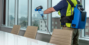 EMist EX7000 in use in a conference room, operator wearing the power pack and harness